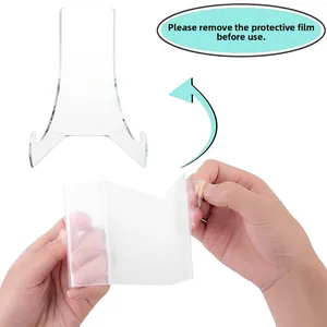 Close-up of removing protective film from clear acrylic display stand to reveal transparency