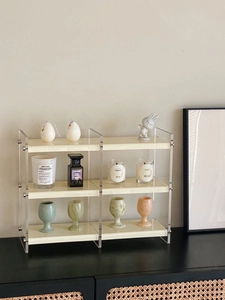 Three-tier acrylic organizer featuring cream shelves for perfume and cosmetics display