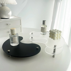Close-up of irregular acrylic coffee trays with ribbed texture on a minimalist desk