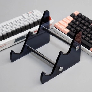 Detalle de un soporte de acrílico negro translúcido para teclados mecánicos