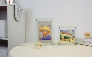 Detail view of transparent acrylic photo frame with corner metal screws and art card