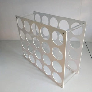 Close-up of 20-hole white acrylic storage rack with transparent support pillars and screws