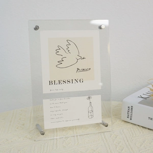 Detail of clear acrylic photo frame with elegant silver metal screw bolts and art card