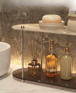 Detail view of the double-layer acrylic bathroom shelf with ribbed glass and gold metal stand