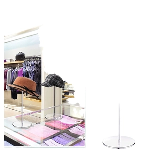 Sleek acrylic hat display stand with round base for showcasing baseball caps and wigs