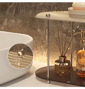 Detail of a two-tier bathroom organizer with acrylic trays and silver steel frame