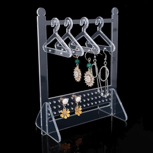 Detailed view of clear acrylic jewelry stand with mini hangers and earring display holes