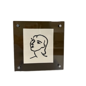 Modern square brown acrylic photo frame with minimalist portrait line art and metal standoffs