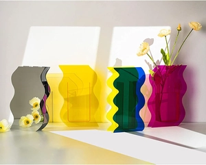 Artistic shadow play on geometric wavy acrylic vases in multiple vibrant colors