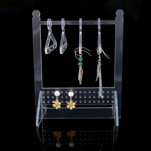 Detailed view of acrylic jewelry organizer with mini hangers for earrings and necklaces