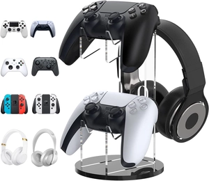 Vertical acrylic gaming stand holding two wireless controllers and one headset