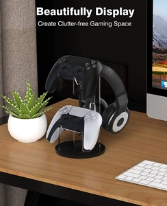 Dual controller and headset stand on desk showing clear acrylic and black round base