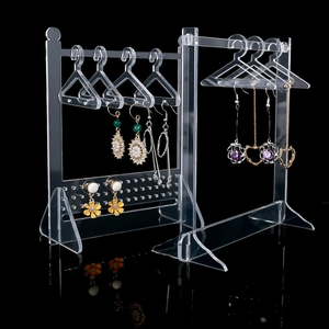 Macro view of clear acrylic jewelry organizer with mini hangers and earring display holes