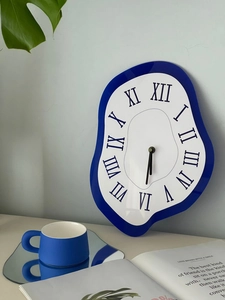 Detail of Surrealist Klein Blue melting clock with Roman numerals on a white dial