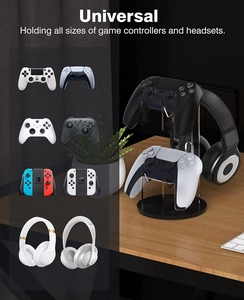 Universal acrylic gaming stand showing dual controllers and headset storage on a desk