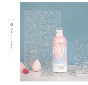 Detail showing 350ml pink amino acid mousse body wash bottle through wavy glass panel