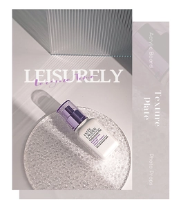 Close-up of whitening essence bottle with pump on ripple glass textured board