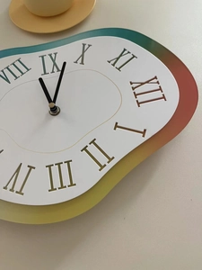 Detail view of melting clock with rainbow gradient edges and golden Roman numerals