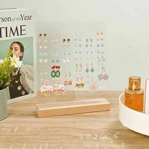 Acrylic earring display stand with wooden base and multiple holes for jewelry organization