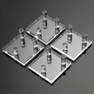 Detailed view of clear acrylic display stands with four cylinder legs in a 4-piece set