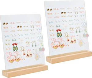 Detail of acrylic earring display stand with wooden base showing various cute studs