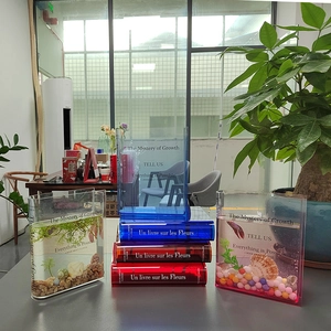 Minimalist book-shaped acrylic vase in multiple colors featuring inspirational text