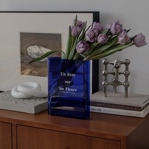 Blue acrylic book-shaped flower vase with artistic typography for home decor display
