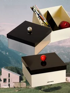 Macro detail of acrylic storage boxes with decorative ball handles and vertical textures