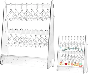 Detail view of clear acrylic earring organizer with mini clothes hanger style jewelry hooks