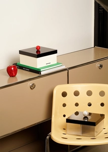 Macro detail of acrylic storage boxes with artful sphere handles and dustproof lids