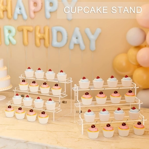 Detail of 3 and 4 tier acrylic cupcake stands showcasing cakes at a birthday party scene