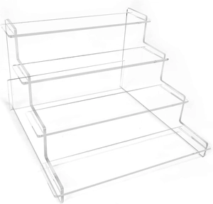 Macro view of clear 4-tier acrylic tiered display stand for perfumes and collectibles