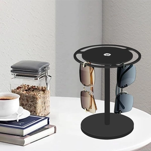 Close-up of a black acrylic 360 rotating sunglasses display stand holding two pairs of glasses