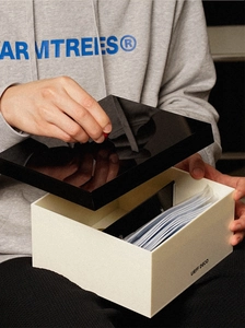 Detailed close-up of a large-capacity acrylic storage box featuring a black lid and logo