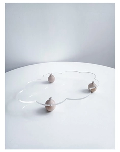 Close-up of cloud-shaped acrylic dessert tray with elegant spherical wooden feet support