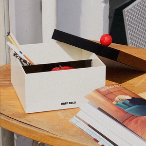 Minimalist acrylic storage box with red ball handle and cream-colored industrial design