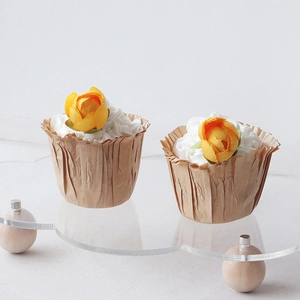 European acrylic cloud cake stand with wood legs and brown cupcake liners for weddings