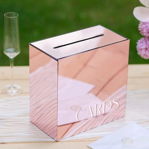 Detail of rose gold mirror wedding card box with CARDS text on white table runner