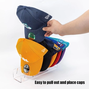 Close-up of clear acrylic baseball cap organizer showing the easy pull-out slot design