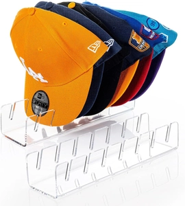 Macro view of clear acrylic baseball cap display rack showing U-shaped slot structure