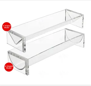Close-up of V-shaped and U-shaped clear acrylic serving trays for food display
