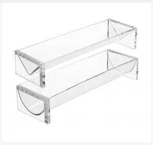 Macro detail of three clear acrylic V-shaped and U-shaped display stands for food or items