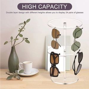 Close-up of 2-tier rotating acrylic sunglasses display stand holding 24 pairs on wood desk
