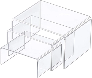 Macro detail of transparent acrylic U-shaped nesting display risers in three sizes