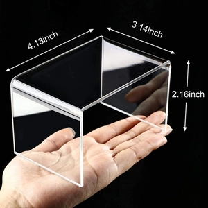 Close-up of clear acrylic U-shaped riser with dimensions for jewelry and cake display