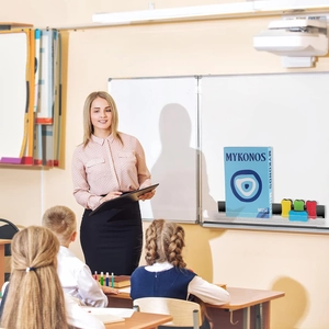 Clear acrylic magnetic shelf for classroom whiteboards holding books and teaching tools