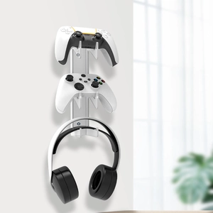Wall-mounted white rack detail for two game controllers and a headset holder