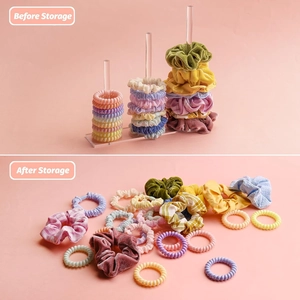 Three-tier clear acrylic scrunchie holder showcasing organized hair accessories on pink background