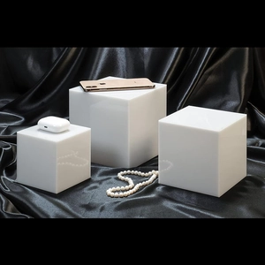 Three-piece set of white acrylic nesting cubes for tiered jewelry and product display