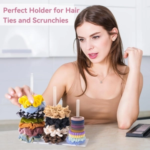 Three-tier clear acrylic scrunchie holder displaying various colorful hair accessories
